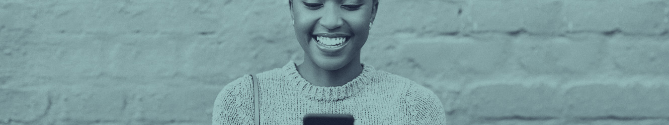 Woman looking at phone and smiling