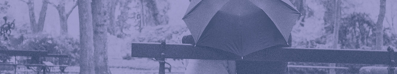 couple on bench under an umbrella