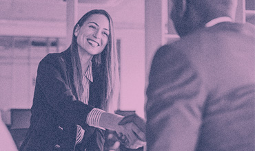 Woman meeting man in business - shaking hands