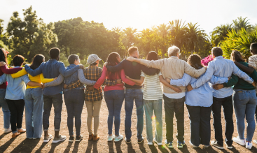 Team of people standing in a line - backs to camera.