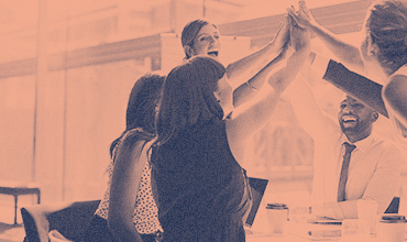 diverse co workers giving high five